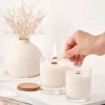 Premium Photo _ Girl lights soy wax candles with a wooden wick handmade candles